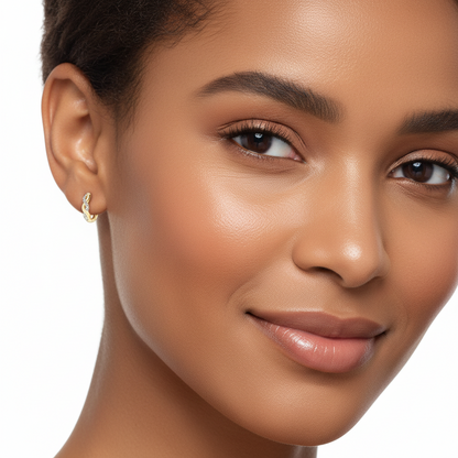 Close-up of a woman's face wearing a gold moissanite earring with a neutral background